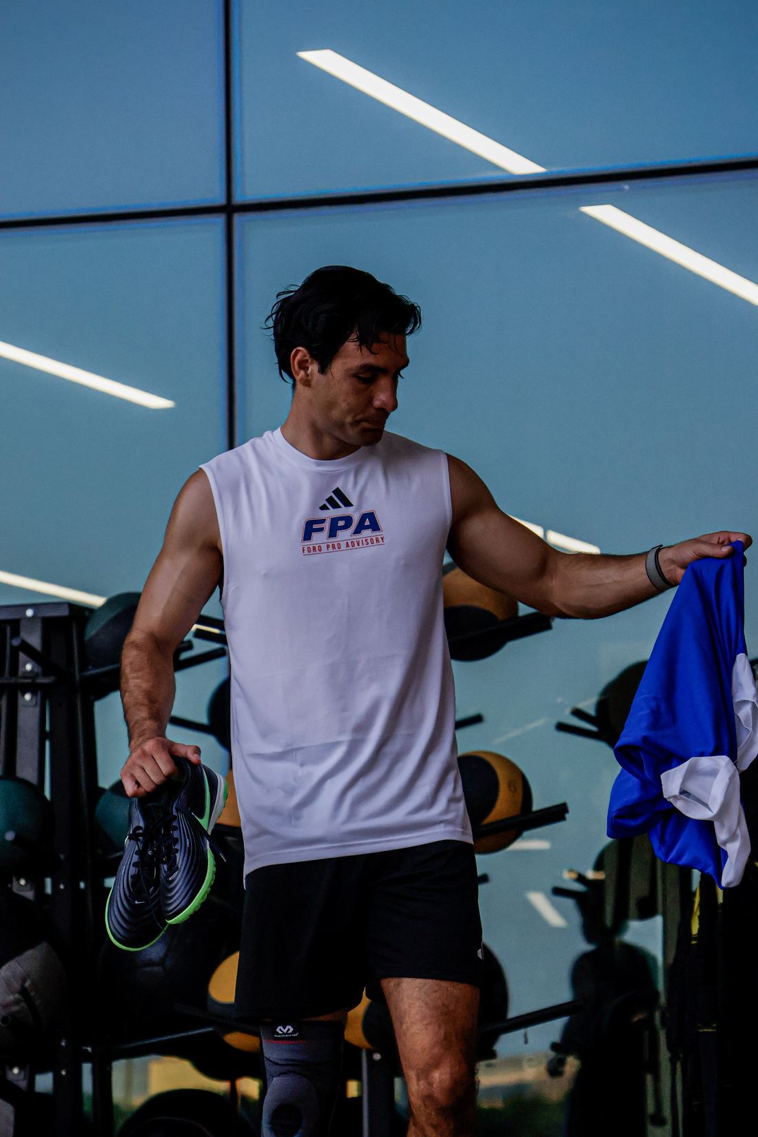 An FPA athlete in Foro Pro Advisory training kit between sets at the EXOS performance floor.